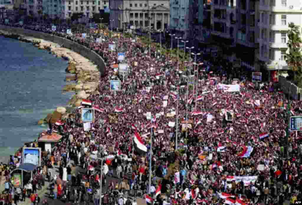 Thousands of Egyptian anti-government protesters march in Alexandria, Egypt, Friday, Feb. 11, 2011. Egypt's military threw its weight Friday behind President Hosni Mubarak's plan to stay in office through September elections while protesters fanned out to