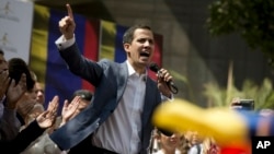 FILE - Juan Guaido, president of the Venezuelan National Assembly delivers a speech during a public session with opposition members, at a street in Caracas, Venezuela, Jan. 11, 2019.
