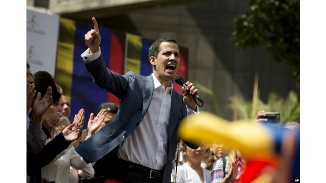 FILE - Juan Guaido, president of the Venezuelan National Assembly delivers a speech during a public session with opposition members, at a street in Caracas, Venezuela, Jan. 11, 2019.