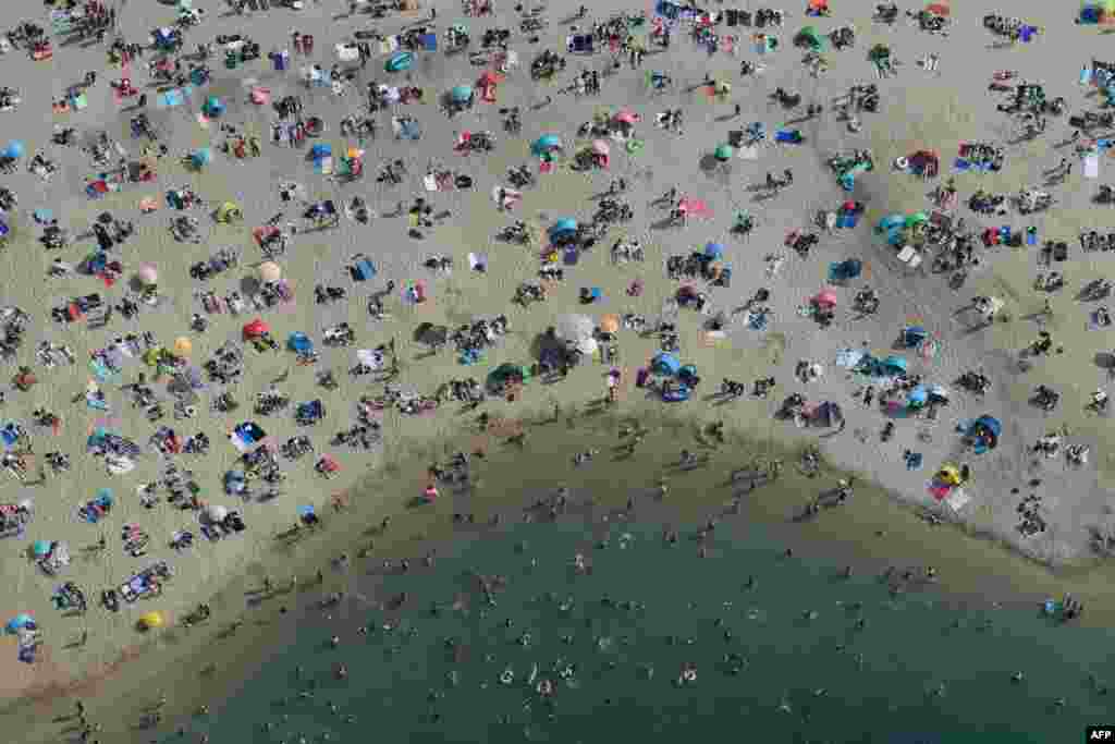 People cool off at a lake in Haltern am See, western Germany, as temperatures rose past 38&deg; C (100.4&deg; F).