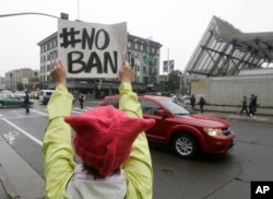 Crissy Pearce holds up a sign outside of the 9th U.S. Circuit Court of Appeals in San Francisco, Feb. 7, 2017.