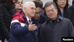 U.S. Vice President Mike Pence and South Korea's President Moon Jae-in attend a speed skating event at the Pyeongchang 2018 Winter Olympics, in Gangneung, South Korea, Feb. 10, 2018.