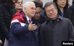 U.S. Vice President Mike Pence and South Korea's President Moon Jae-in attend a speed skating event at the Pyeongchang 2018 Winter Olympics, in Gangneung, South Korea, Feb. 10, 2018.