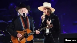 Willie Nelson and Brandi Carlile perform during a gala event honoring Dolly Parton as the MusiCares person of the year, ahead of the Grammy Awards, in Los Angeles, Feb. 8, 2019.