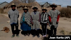 Members of the Choque family, from left, Jose, Evarista Flores, Rufino, Abelina and Abdon, pose for a photo in the Urus del Lago Poopo indigenous community, in Punaca, Bolivia, Sunday, May 23, 2021. 