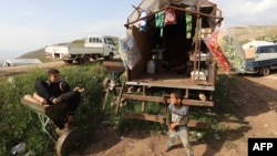 Syrian children whose families fled the western countryside of Hama are pictured in a makeshift camp in Sher Maghar, Hama province, April 27, 2019. Syrian troops' push into rebel-held Kfar Nabudah on May 8, 2019, caused fresh displacement of civilians in the region.