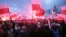 Protesters carry Polish flags and National Radical Camp flags during a rally, organized by far-right, nationalist groups, to mark 99th anniversary of Polish independence in Warsaw, Nov. 11, 2017.