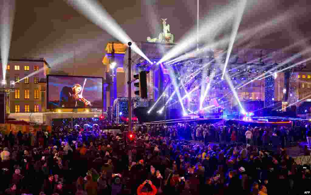 People attend the New Year's eve party at Berlin's landmark Brandenburg Gate, Germany, Dec. 31, 2014.
