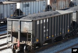 FILE - Coal cars fill a rail yard in Williamson , W.Va., Nov. 11, 2016. The hard-eyed view along the Tug Fork River in coal country is that Donald Trump has to prove he'll help Appalachian mining like he promised.