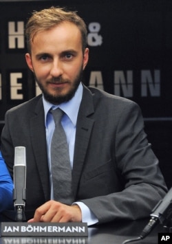 In this Aug. 28, 2012, photo, German comedian Jan Boehmermann is seen hosting a talk show in Cologne, western Germany. A recent poem by Bohmerman lampooning Erdogan has prompted the Turkish president to launch his latest free speech challenge.