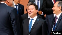 FILE - Turkey's Deputy Prime Minister Ali Babacan gathers with other delegates for a photo after a meeting of G-20 finance ministers and central bank governors during the IMF-World Bank annual meetings in Washington, Oct. 10, 2014. 