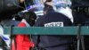 FILE - A French police officer speaks with a veiled Muslim woman during an identity check in Lille Sept. 22, 2012.