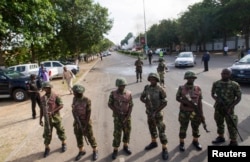 FILE - Nigerian army soldiers stand guard in Abuja, June 25, 2014.