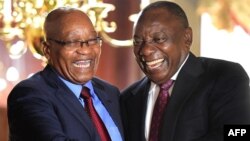 FILE: In this handout photograph released by the South African Government Communication and Information System (GCIS) on February 20, 2018, South Africa's President Cyril Ramaphosa (R) shakes hands with his predecessor Jacob Zuma at a farewell cocktail function for Zuma.