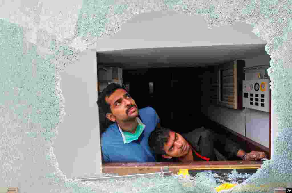 Staff watch the rescue operations after their hospital caught fire. (Reuters)