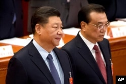 资料照：中国国家主席习近平与总理李克强在北京人大会堂出席全国人大会议闭幕式。（2019年3月15日）