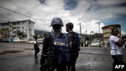 FILE - Cameroonian policemen patrol the market in the majority English-speaking province in Buea, Cameroon.