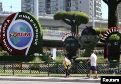 People walk past an installation set up ahead of the Forum on China-Africa Cooperation (FOCAC), in Beijing, China, Aug. 24, 2018.