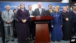 Iraqi former Parliament speaker and the chairman of the Sunni Arab Coalition Osama al-Nujaifi, center, speaks to the media during a press conference in Baghdad, Iraq, July 13, 2014. 