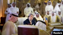 U.S. Secretary of State John Kerry (C) listens while Oman's Foreign Minister Yusuf bin Alawi (L) speaks during a meeting of foreign ministers of the Gulf Cooperation Council (GCC) in Doha Aug. 3, 2015. 
