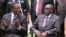 FILE: Emmerson Mnangagwa, left, then Vice President of Zimbabwe chats with Zimbabwean President Robert Mugabe after the swearing in ceremony at State House in Harare, Friday, Dec, 12, 2014.