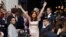 Argentina's President Cristina Fernandez greets supporters as she arrives for the opening session of the 133rd legislative term of Congress in Buenos Aires, March 1, 2015. 