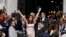FILE - Argentina's President Cristina Fernandez greets supporters as she arrives for the opening session of the 133rd legislative term of Congress in Buenos Aires, March 1, 2015.