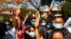 Supporters show a three-finger salute of protest while four arrested activists appear in court in Mandalay, Myanmar, Feb. 5, 2021. Hundreds of students and teachers have taken to Myanmar's streets to demand the military return power to elected officials.