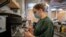Waiter Sara Palacios prepares a coffee as she works at La Francachela restaurant in Madrid, Spain, March 26, 2021.