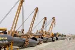 FILE - Sections of pipes are seen at the start of construction on a natural gas pipeline in Chabahar, southeastern Iran, March 11, 2013.
