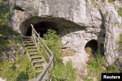 The entrance to Denisova Cave in the Altai Mountains in southern Siberia near the Russia-Mongolia border where the remains of a female Neanderthal were found is shown in this 2011 photo released Feb. 17, 2016. 