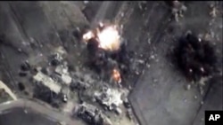 In this photo made from the footage taken from Russian Defense Ministry official web site on Oct. 1, 2015 a bomb explosion is seen in Syria. 