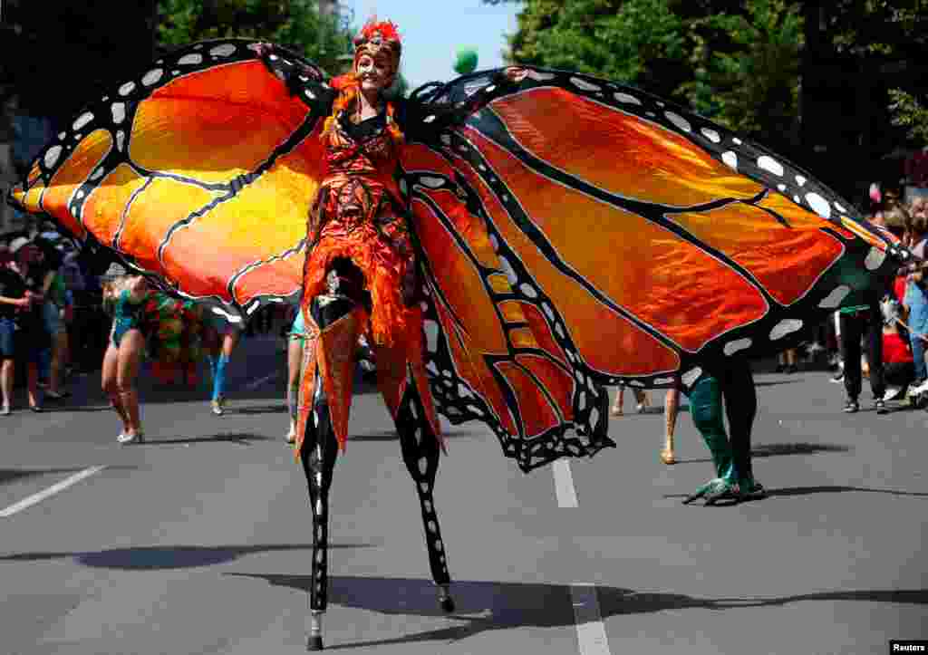 A performer takes part in the annual street parade, which is part of the Carnival of Cultures celebrating the multi-ethnic diversity of the city, in Berlin, Germany.