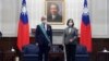 FILE - Taiwanese President Tsai Ing-wen, right poses for a photo after awarding a medal of honor to Alain Richard, the head of the French Senate's Taiwan Friendship Group, at the Presidential Office in Taipei, Taiwan, Oct. 7, 2021.