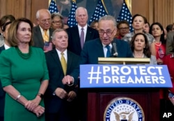 FILE - Senate Minority Leader Chuck Schumer of New York, accompanied by House Minority Leader Nancy Pelosi of California, left, and other congressional Democrats, speaks during a news conference on Capitol Hill in Washington, Sept. 6, 2017.