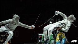 China&#39;s Li Hao, left, competes with Ukraine&#39;s Artem Manko during the men&#39;s sabre individual category A gold medal wheelchair fencing bout at the Tokyo 2020 Paralympic Games at the Makuhari Messe Hall in Chiba.