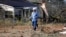 A Central Electric Power Association lineman pulls a new line across the debris littered lawn of a Scott County, Mississippi resident, Nov. 30, 2016, that was damaged by an apparent tornado Tuesday afternoon. With crowd-sourced mapping rescue workers will have the information they need, such as which roads, buildings and bridges have been destroyed.  