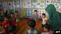 In this photo taken on September 12, 2024, Shonjida, a Rohingya woman teaches at a school in a refugee camp in Ukhia.