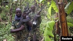 M23 rebel fighters are pictured as they withdraw near the town of Sake, some 42 km west of Goma on Nov. 30, 2012.