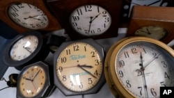 FILE - Clocks are displayed at Electric Time Company on Nov. 1, 2022, in Medfield, Massachusetts. (AP Photo/Charles Krupa)