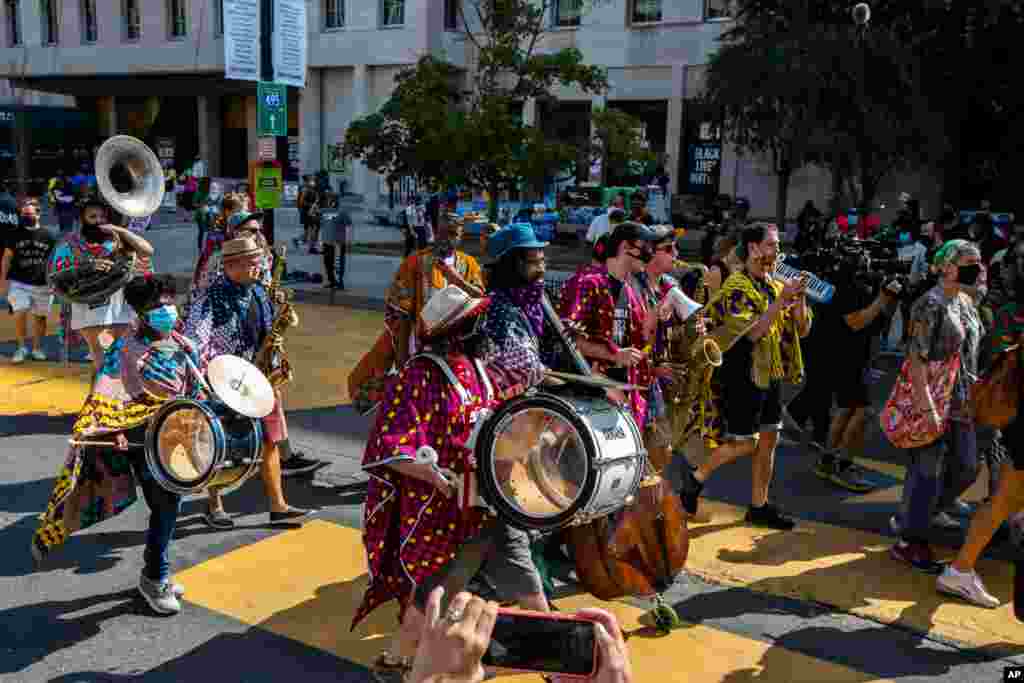 A band from New York and Philadelphia area plays as they march at Black Lives Matter Plaza near the White House in Washington, to join other marchers during the March on Washington, Aug. 28.
