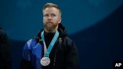 Silver medal winner Sweden's Niklas Edin stands on the podium during the men's curling venue ceremony at the 2018 Winter Olympics in Gangneung, South Korea, Feb. 24, 2018.