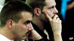 Norwegian citizens Tjostolv Moland (l) and Joshua French during their trial in Kisangani, Congo, Dec. 3, 2009.