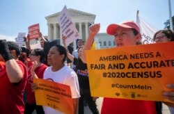 FILE - Demonstrators are seen at the Supreme Court as justices deliberate on a census case involving an attempt by the Trump administration to include a citizenship question in the 2020 census, on Capitol Hill in Washington, June 27, 2019.