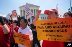 FILE - Demonstrators are seen at the Supreme Court as justices deliberate on a census case involving an attempt by the Trump administration to include a citizenship question in the 2020 census, on Capitol Hill in Washington, June 27, 2019.
