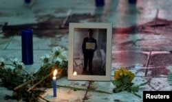 A portrait of Rodrigo Quintana, who was killed early April 1, 2017, by a rubber bullet fired by the police in the headquarters of the Liberal Party after clashes, is placed next to his bloodstains in Asuncion, Paraguay.