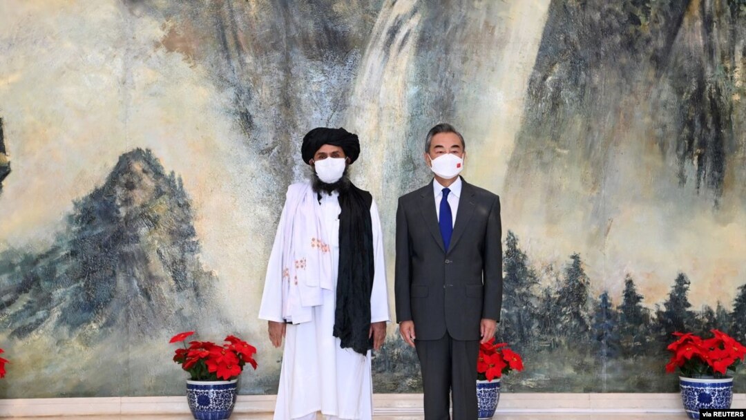 وەزیری دەرەوەی چین وانگ یی و سیاسەتمەداری باڵای تاڵیبان مەلا عەبدول غەنی برادار لە تیانجین، چین