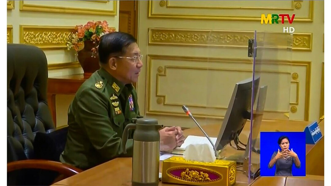 Military chief General Min Aung Hlaing chairs the first cabinet meeting following a coup, at the Presidential Palace in Naypyidaw, in this screengrab provided via AFPTV and taken from a broadcast by Myanmar Radio and Television, Feb. 2, 2021 .