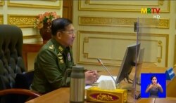 Military chief General Min Aung Hlaing chairs the first cabinet meeting following a coup, at the Presidential Palace in Naypyidaw, in this screengrab provided via AFPTV and taken from a broadcast by Myanmar Radio and Television, Feb. 2, 2021 .