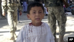 An Afghan boy, who lost his father in a suicide attack, walks around a hospital in a daze in Maymana, Faryab province north west of Kabul, Afghanistan, October 26, 2012.